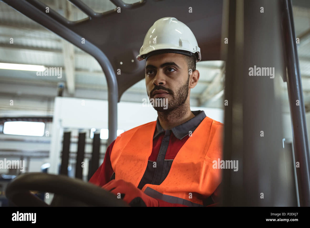 Male worker driving forklift Stock Photo