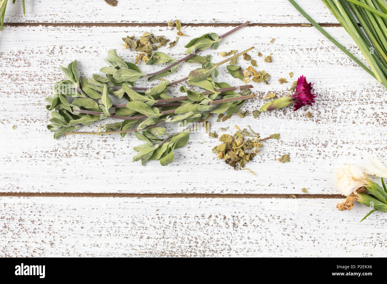 Fresh and Dry Marjoram herbs on a rustic table top with edible flowers Stock Photo Alamy