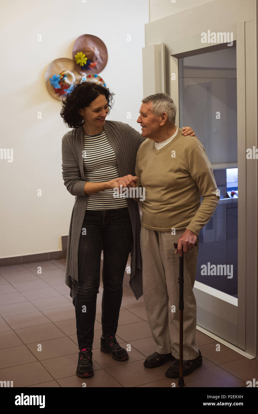 Caretaker talking to senior man Stock Photo