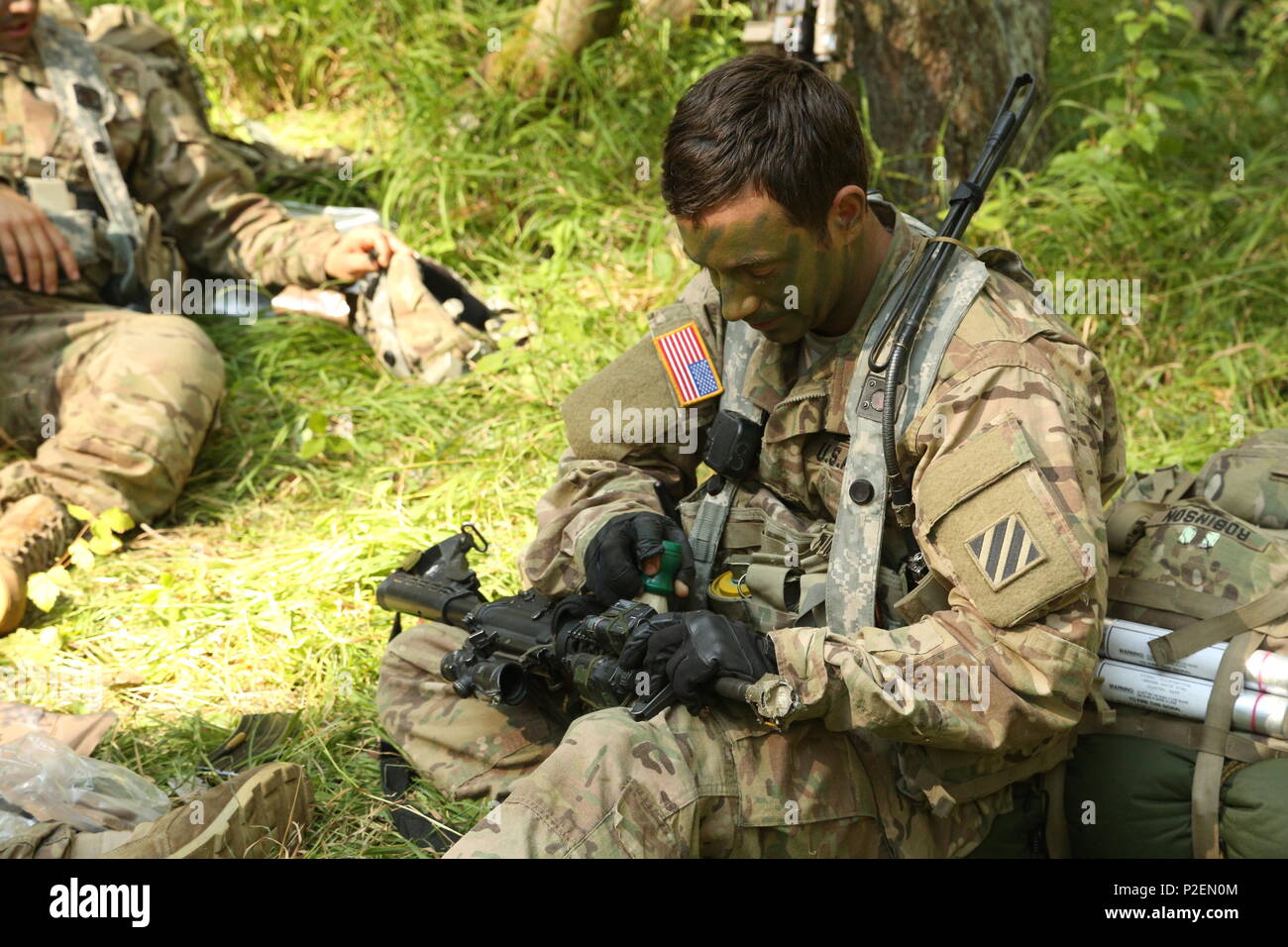 A U.S. Soldier of Charlie Company, 1st Battalion, 30th Infantry Regiment, 2nd Infantry Brigade conducts maintenance on a M4A1 Carbine while conducting a resupply operation during exercise Combined Resolve VII at the U.S. Army’s Joint Multinational Readiness Center in Hohenfels Germany, Sep. 7, 2016. Combined Resolve VII is a 7th Army Training Command, U.S. Army Europe-directed exercise, taking place at the Grafenwoehr and Hohenfels Training Areas, Aug. 8 to Sept. 15, 2016. The exercise is designed to train the Army’s regionally allocated forces to the U.S. European Command. Combined Resolve VI Stock Photo