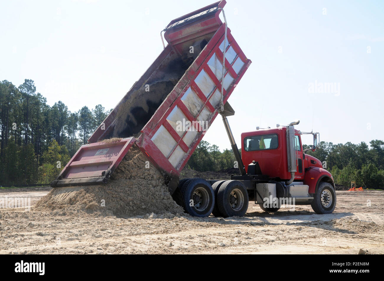 One of 40,000 dump trucks unloads at the Raw Water Storage Impoundment site, which is approximately 30 percent complete. The impoundment is part of the Savannah Harbor Expansion Project. Stock Photo