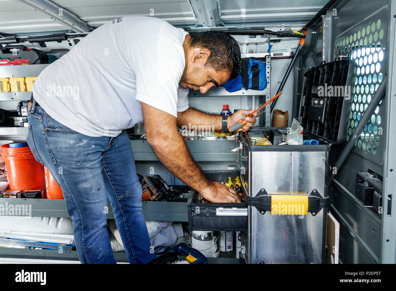 Miami Beach Florida,Hispanic,immigrant immigrants,man men male,contractor,repairman,inside van,tools,searching,working,tool chest,FL170911005 Stock Photo