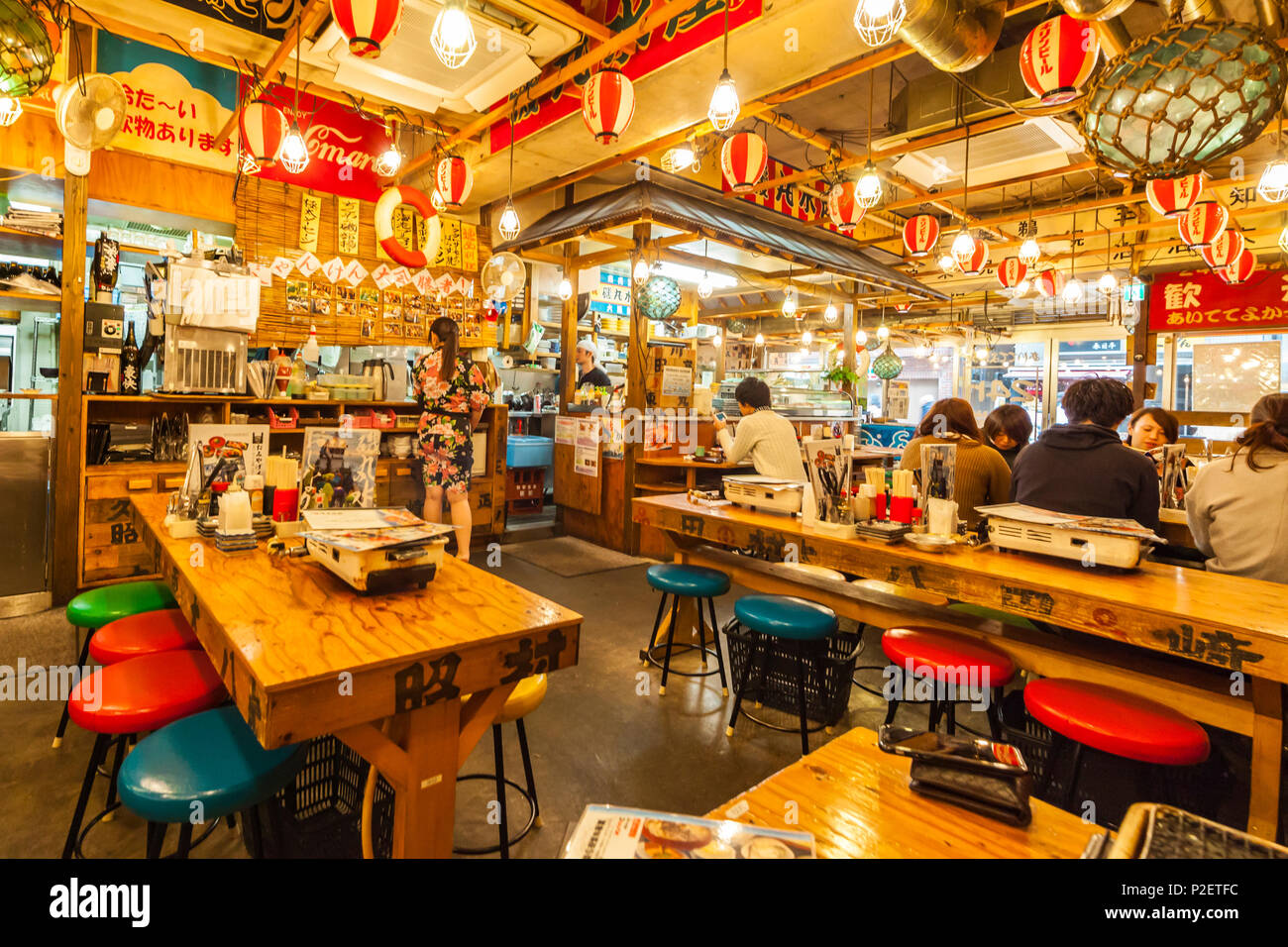 Young people eating and drinking at Izakaya in Shinjuku, Tokyo, Japan Stock Photo