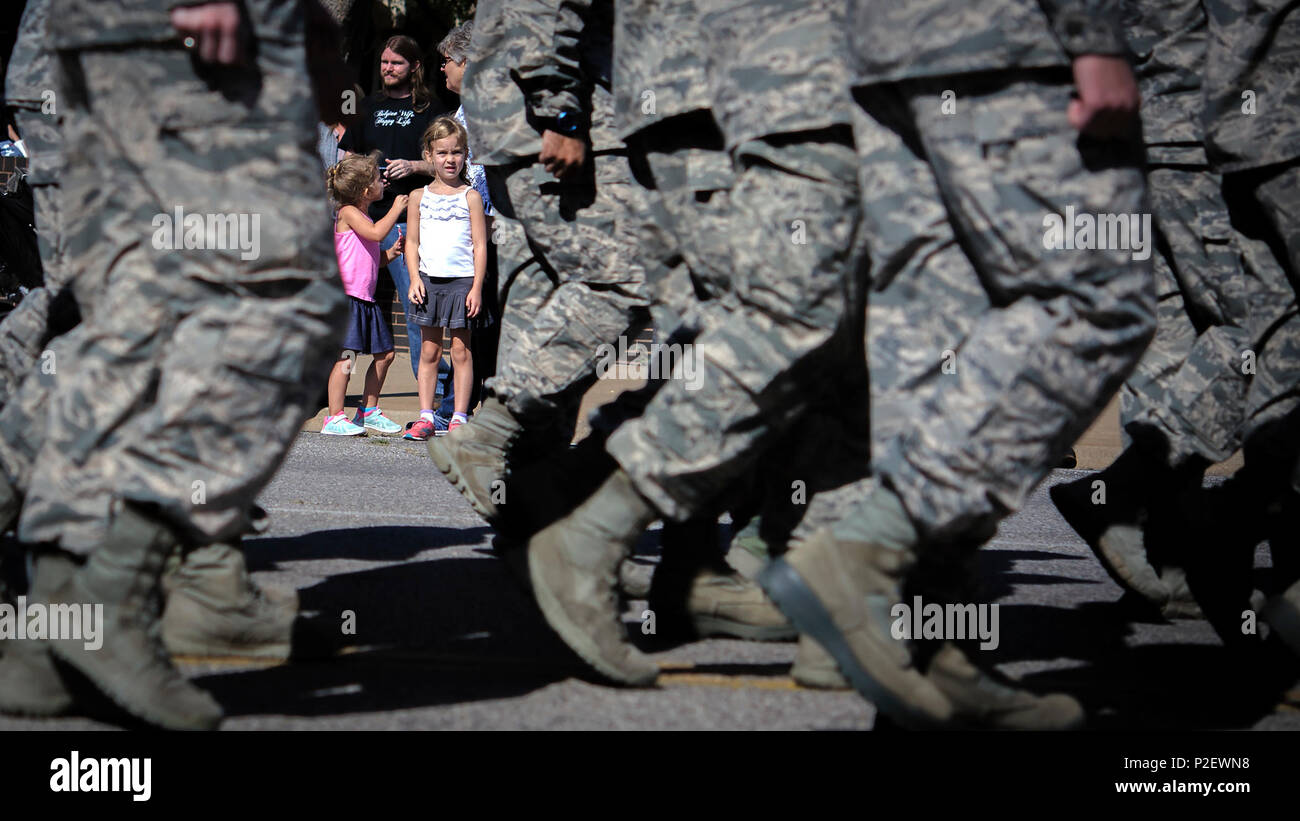 A local kid watches Vance Air Force Base Airmen march in Enid, Oklahoma, Sept. 17. The parade was part of Enid's annual two-day Cherokee Strip Celebration, which celebrates the history of the Land Run of 1893. (U.S. Air Force photo by David Poe) Stock Photo