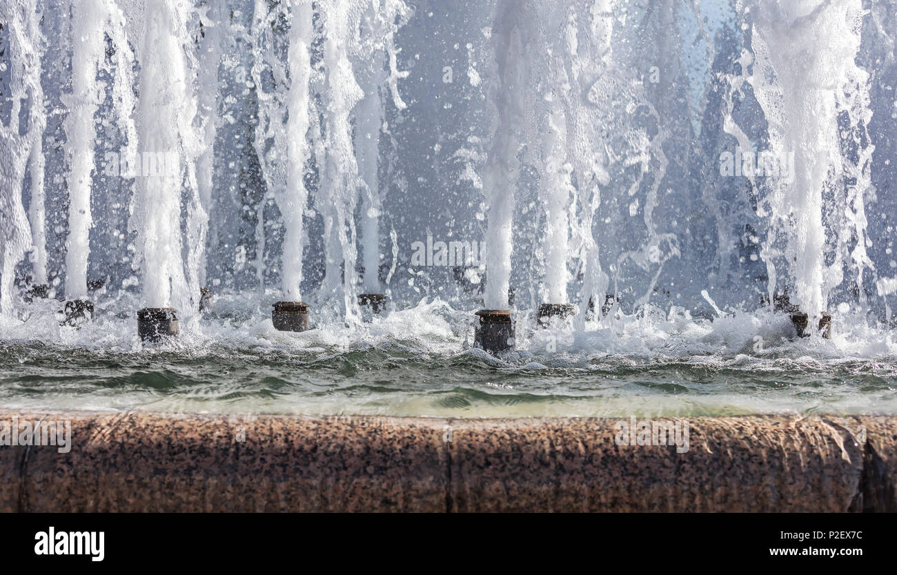 splashes of fountain water in a sunny day. natural background Stock Photo