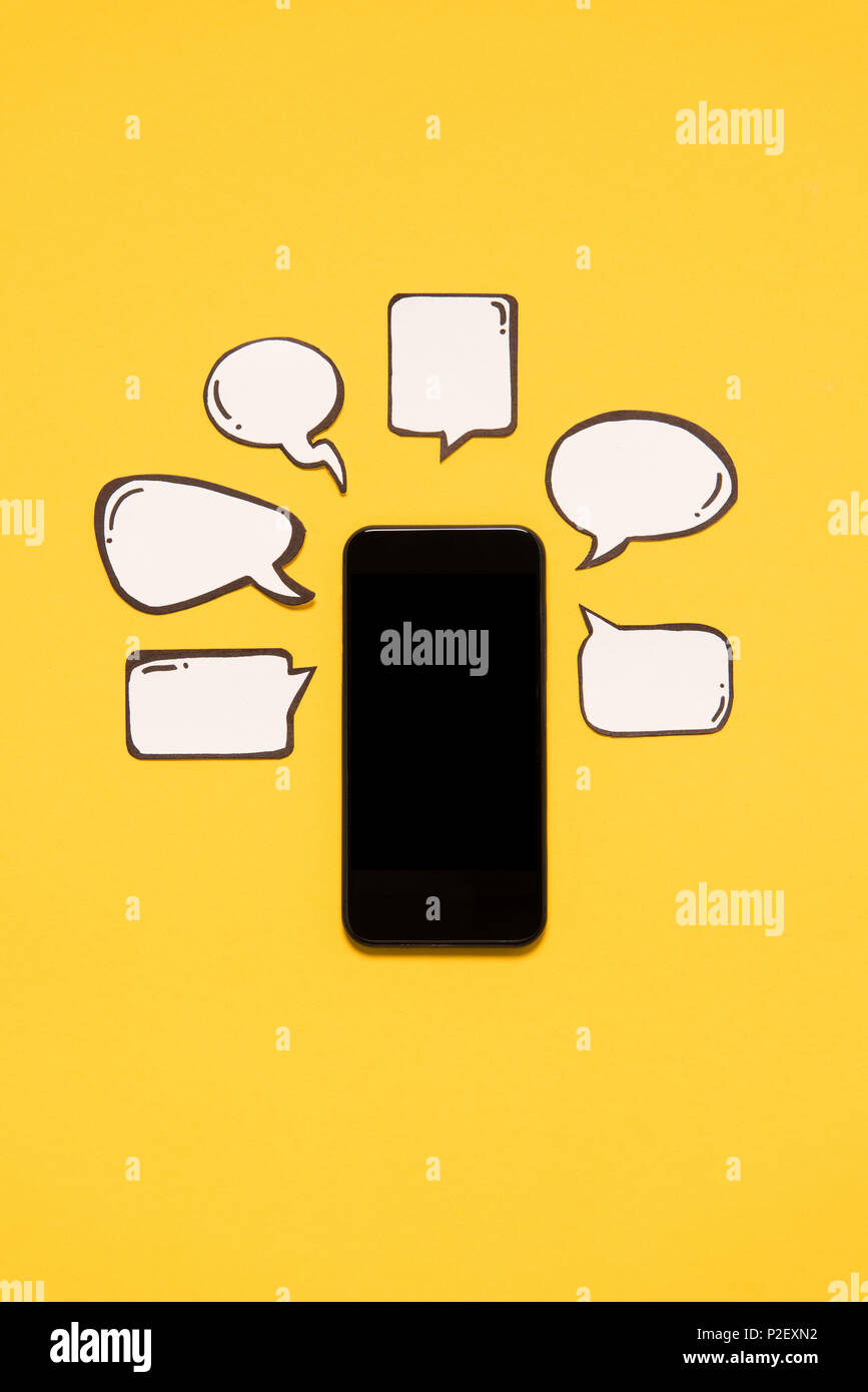 Close-up view of smartphone with black screen and blank speech bubbles ...
