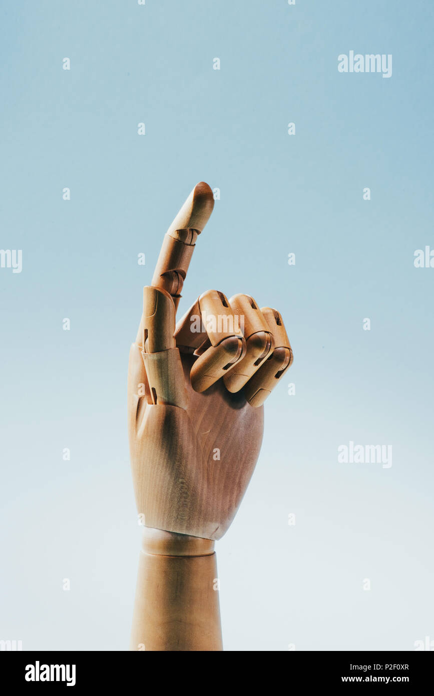 close up view of wooden puppet hand isolated on blue Stock Photo