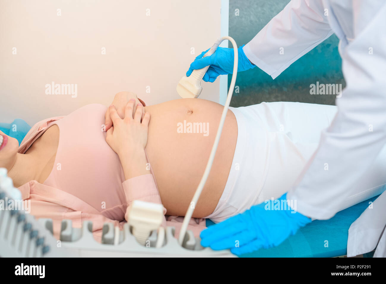 cropped shot of obstetrician gynecologist making of ultrasound examination pregnant woman Stock Photo