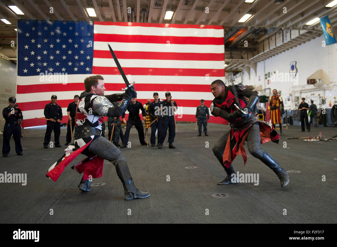 160901-N-MZ309-134 SAN PEDRO, California (Sept. 1, 2016) – Knights from the family dinner theater restaurant Medieval Times perform for Sailors on board amphibious assault ship USS America (LHA 6) in the ship’s hangar bay during the inaugural Los Angeles Fleet Week. Fleet week offers the public an opportunity to tour ships, meet Sailors, Marines, and members of the Coast Guard and gain a better understanding of how the sea service support the national defense of the United States and freedom of the seas. (U.S. Navy photo by Mass Communication Specialist 1st Class Ryan Riley/Released) Stock Photo