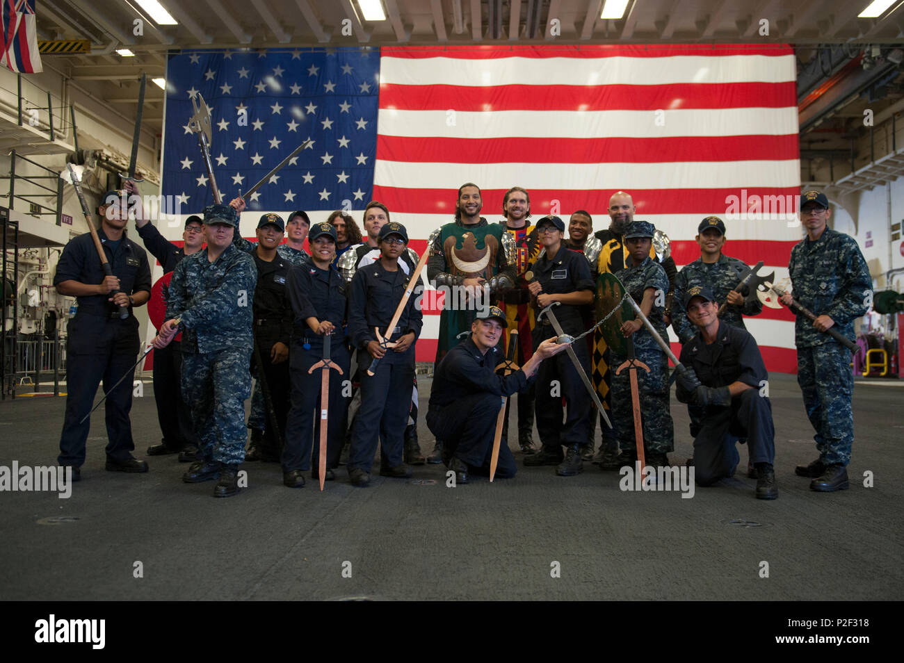 160901-N-MZ309-139 SAN PEDRO, California (Sept. 1, 2016) – Knights from the family dinner theater restaurant Medieval Times pose for a photo with Sailors assigned to amphibious assault ship USS America (LHA 6) in the ship’s hangar bay during the inaugural Los Angeles Fleet Week. Fleet week offers the public an opportunity to tour ships, meet Sailors, Marines, and members of the Coast Guard and gain a better understanding of how the sea service support the national defense of the United States and freedom of the seas. (U.S. Navy photo by Mass Communication Specialist 1st Class Ryan Riley/Releas Stock Photo