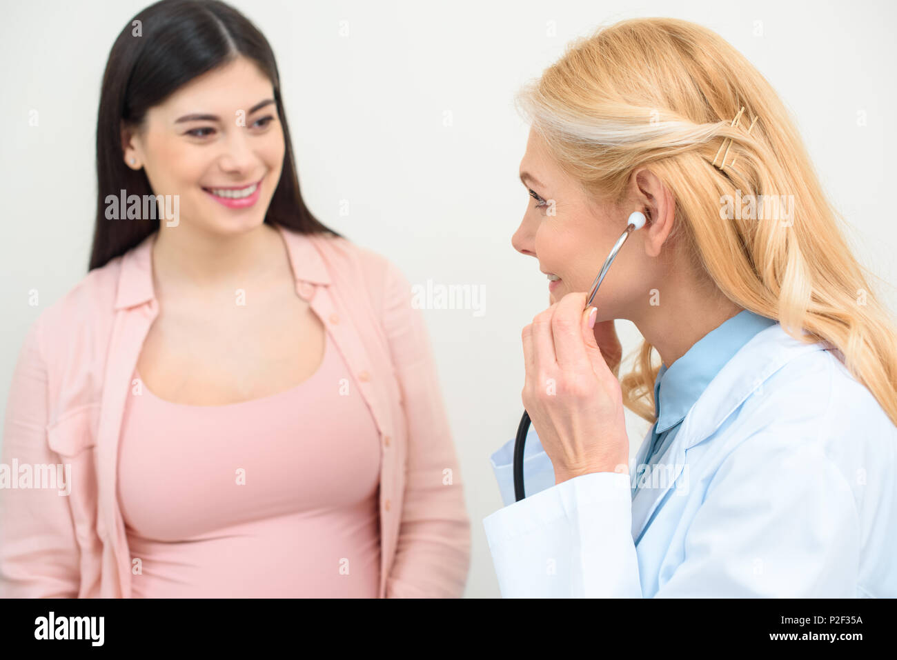 closeup shot of obstetrician gynecologist listening heartbeat of child