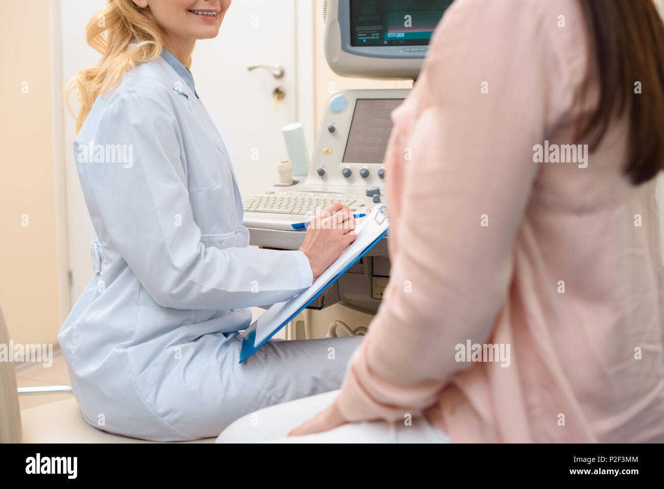 cropped shot of obstetrician gynecologist consulting pregnant woman at ultrasound scanning office Stock Photo