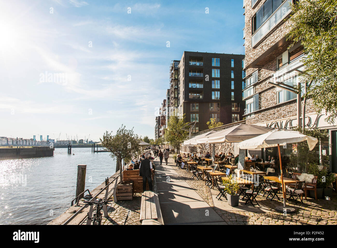 People chilling at the Dalmannkai in the Hafencity of Hamburg, north Germany, Germany Stock Photo