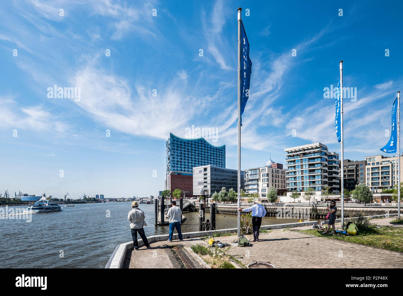 people fishing at Grasbrock harbour with view to the new Elbphilharmonie, Hafencity of Hamburg, north Germany, Germany Stock Photo