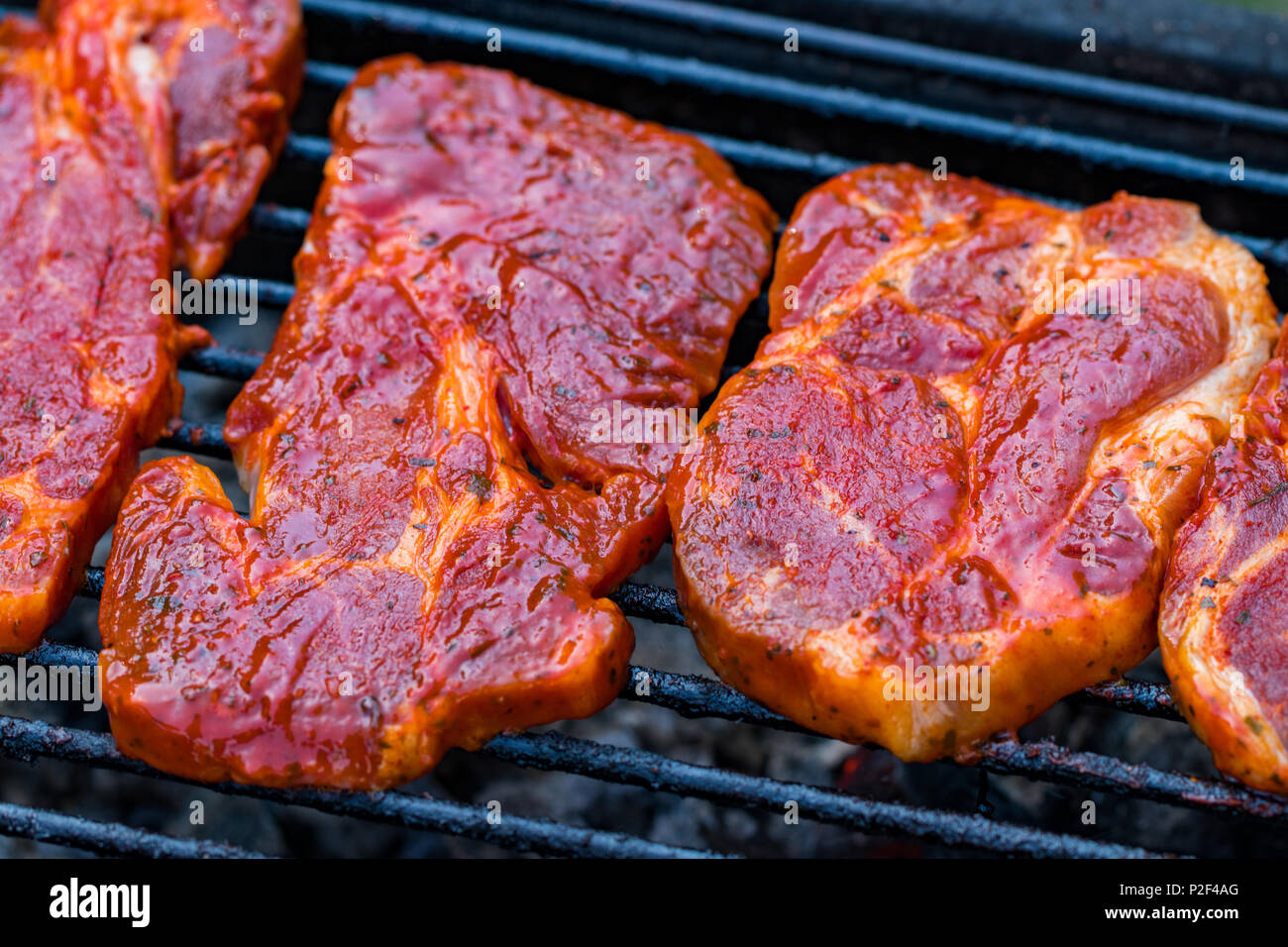 Beef steaks on the grill with flames Stock Photo - Alamy