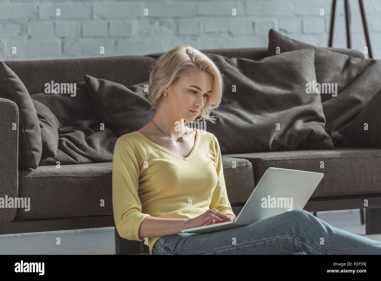 beautiful girl sitting of floor and using laptop Stock Photo - Alamy