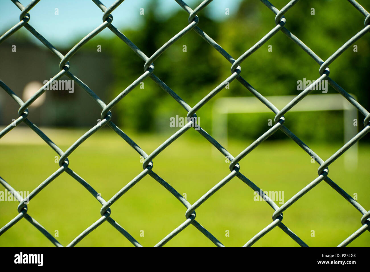chain link fence with field in the back Stock Photo
