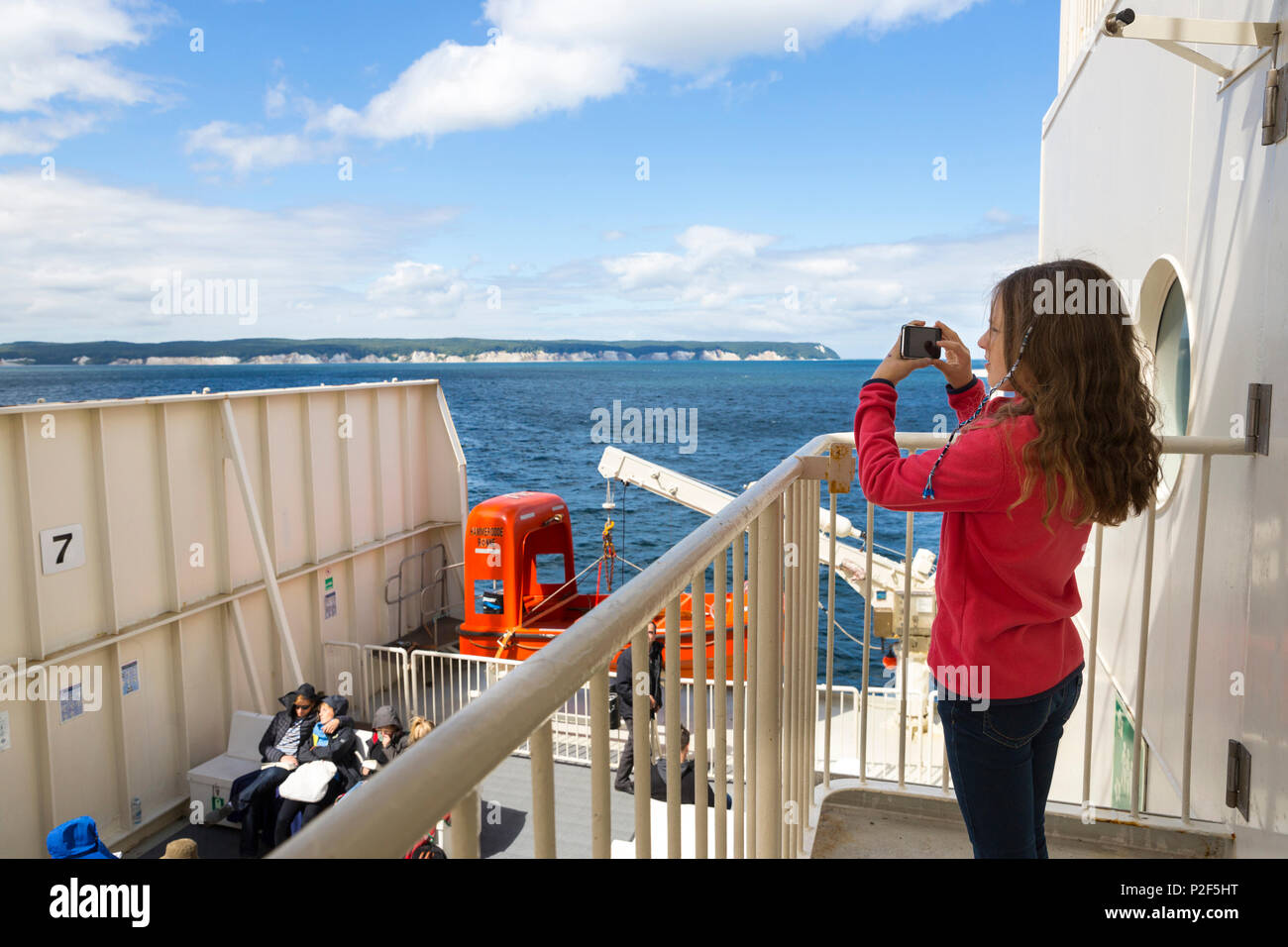 Baltic sea, ferry, transfer from Germany to Denmark, girl taking photos with her mobile phone, chalk cliffs, Ruegen island, Meck Stock Photo