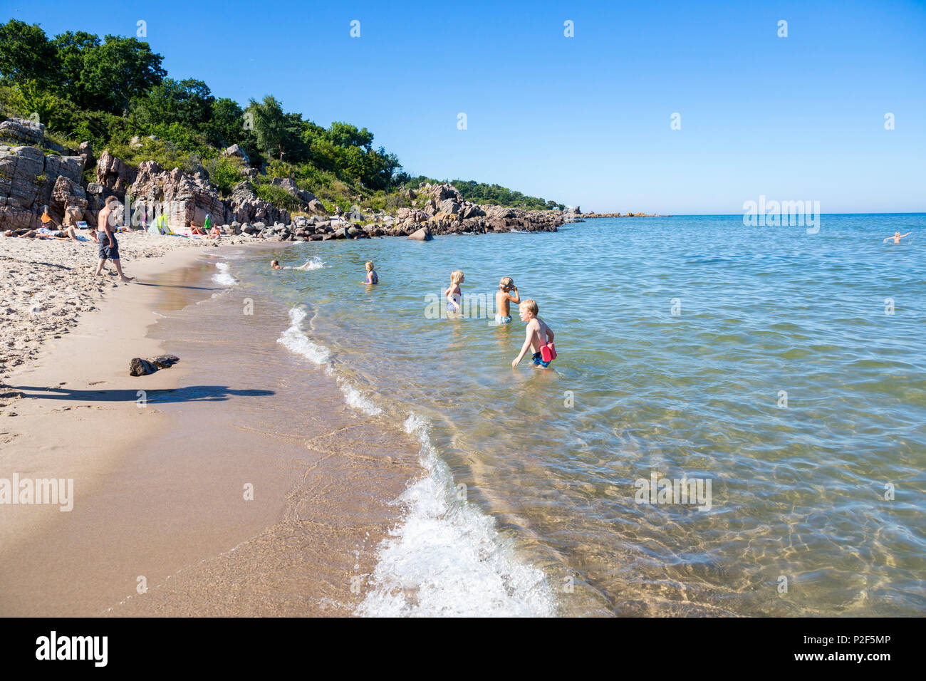 Family bathing in the sea, Sandkas beach, Summer, Holiday, Baltic sea, Bornholm, south of Sandvig and Allinge, east coast, Denma Stock Photo