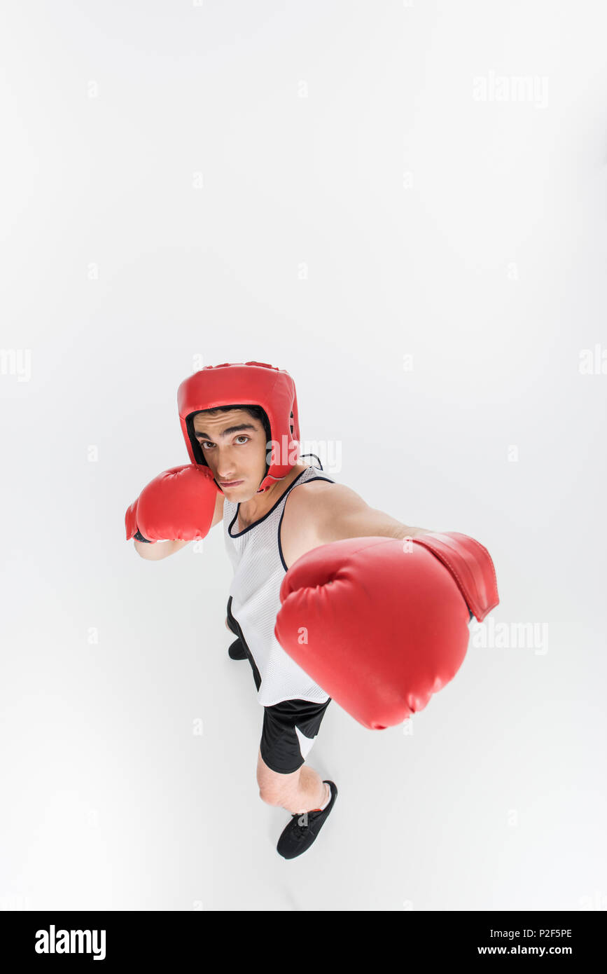 High angle view of skinny sportsman in boxing gloves and helmet