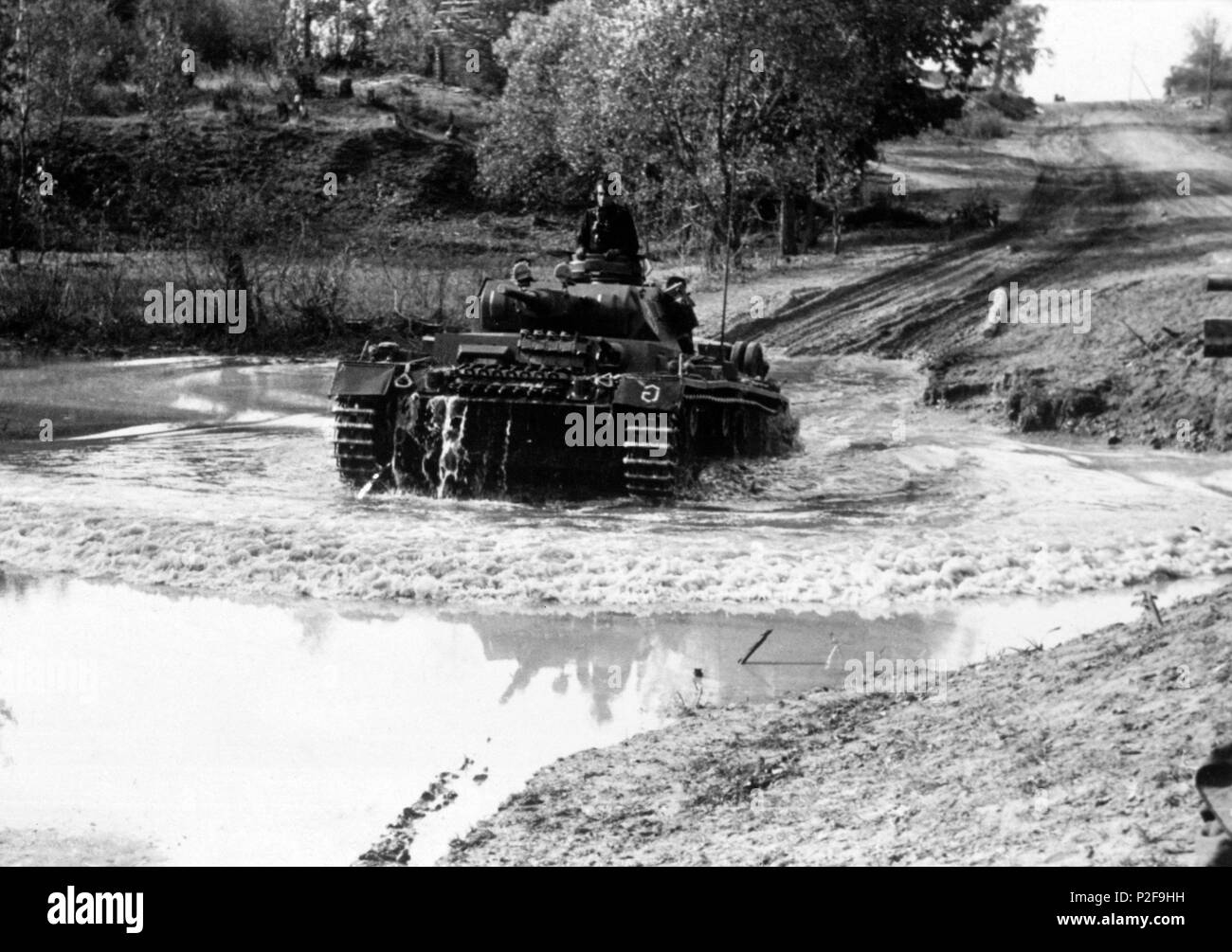 WWII. Eastern Front .Tiger tank plowing through flooded road. Stock Photo