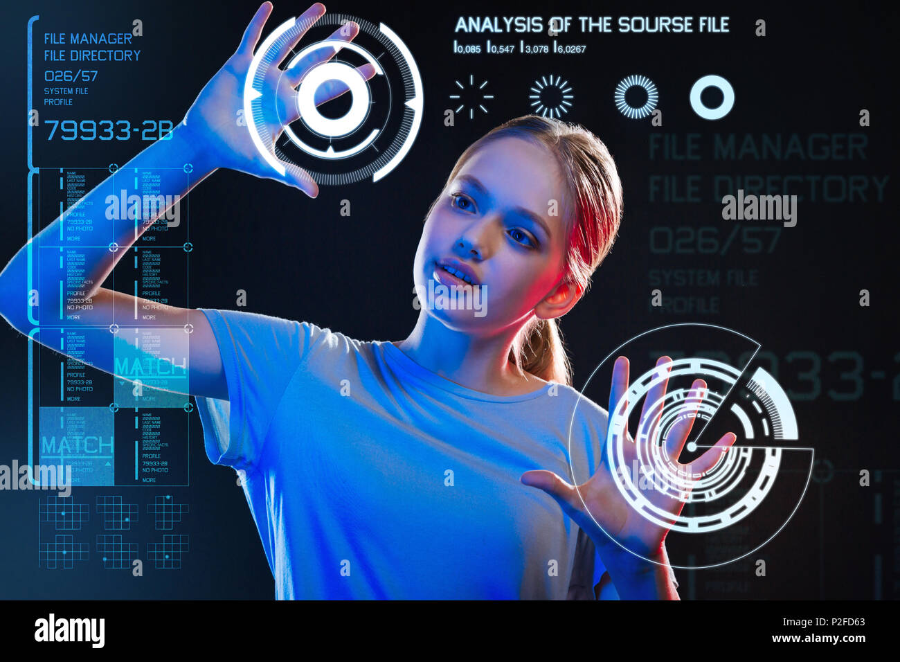 Curious girl touching the holograms and feeling interested Stock Photo ...