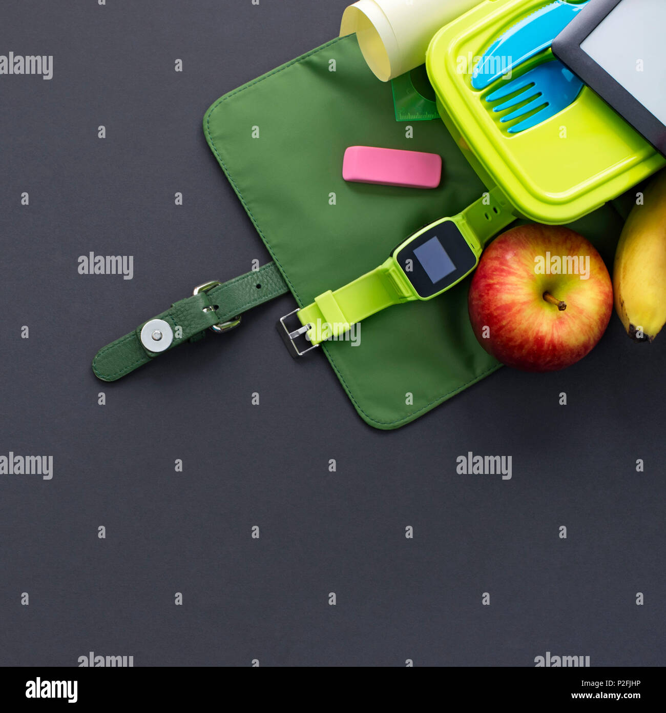 Backpack with school supplies on black background. Top view Flat lay Stock Photo