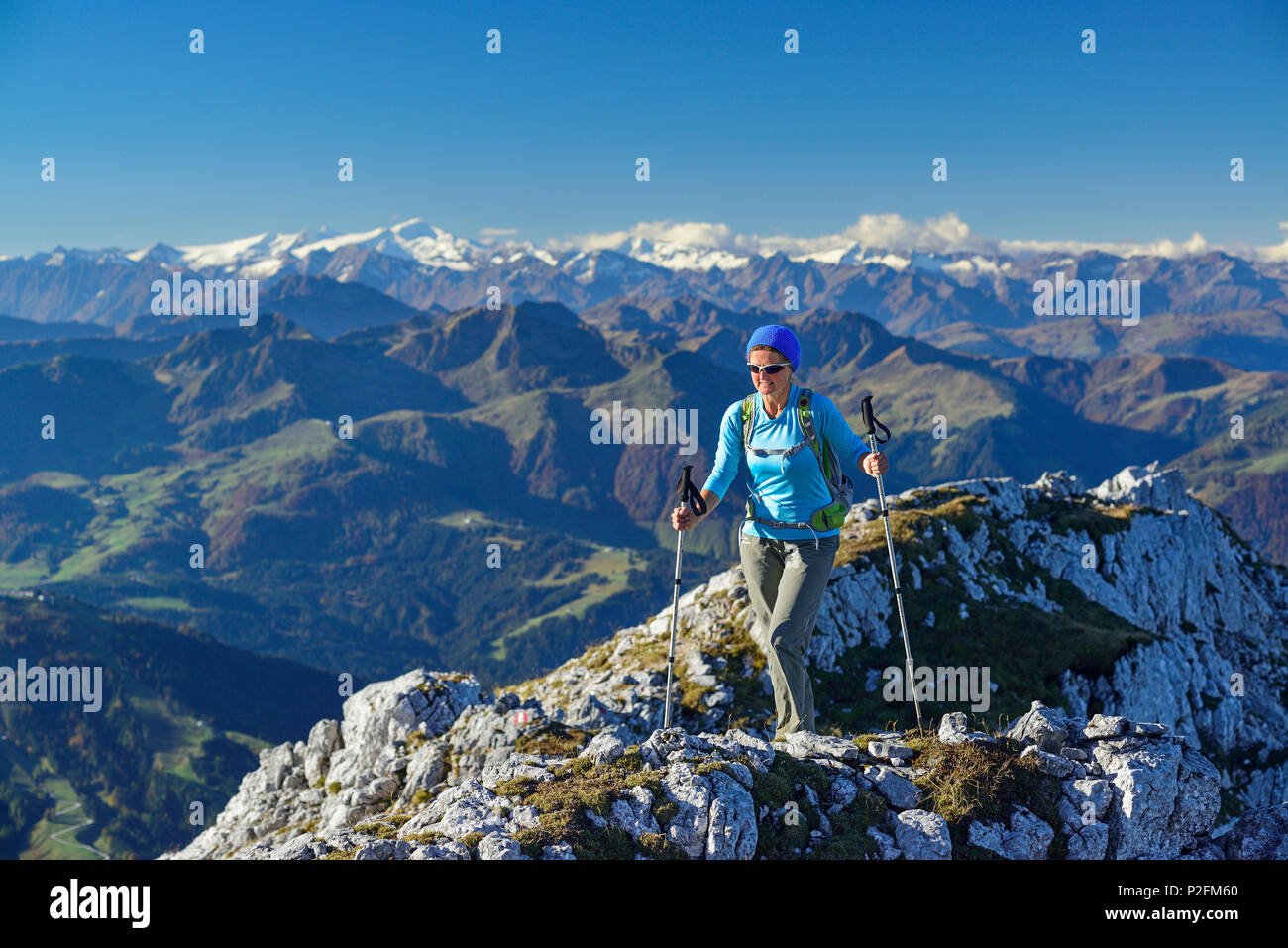 Woman hiking on ridge with Grossvenediger in the background, Nurracher Hoehenweg, Ulrichshorn, Loferer Steinberge range, Tyrol, Stock Photo