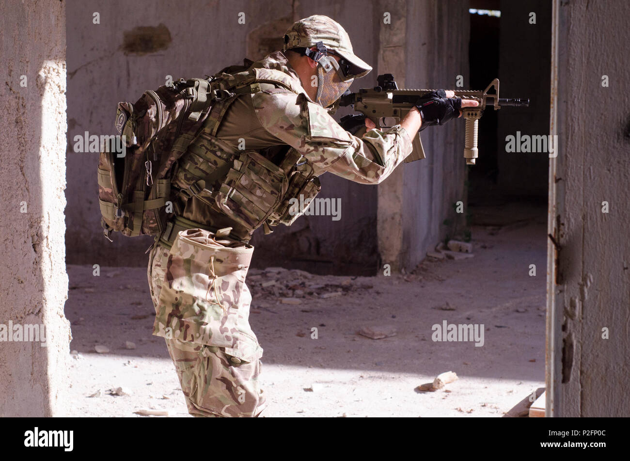 Special forces soldier inside building aim target rifle Stock Photo
