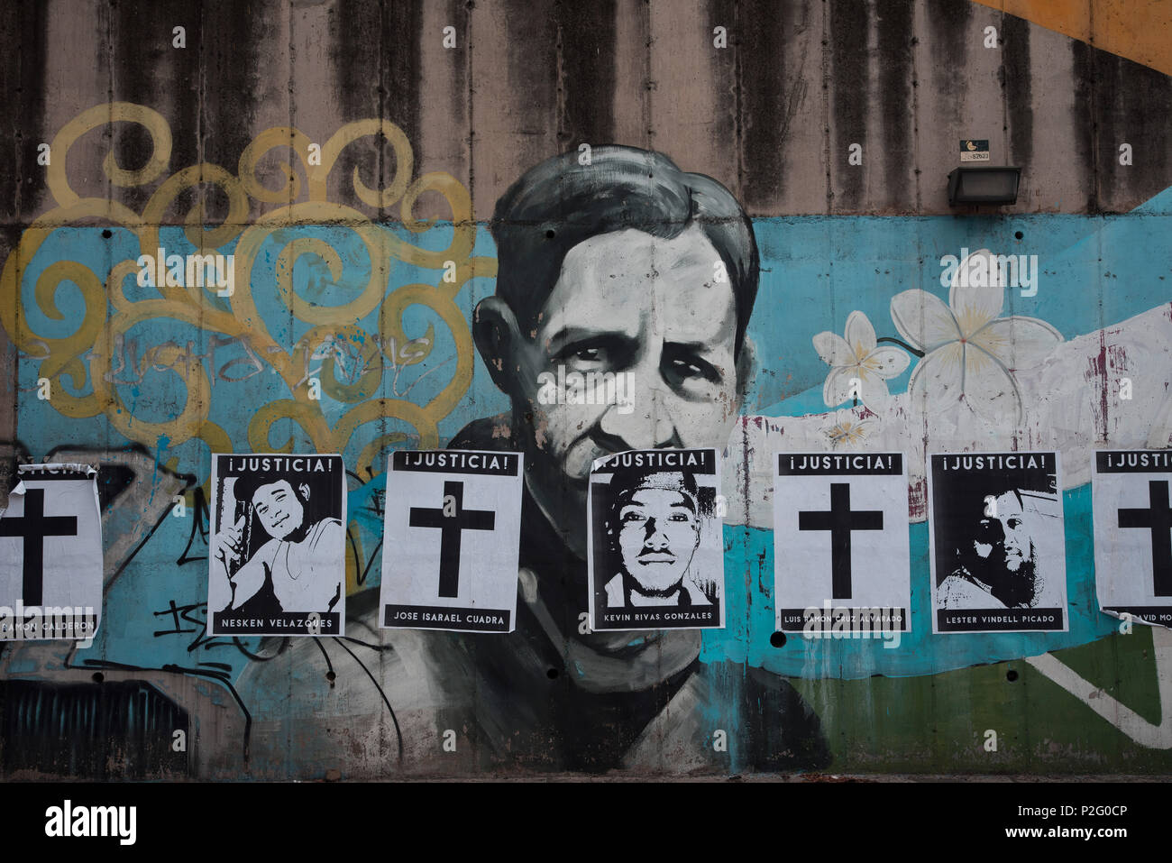 14 June 2018, Nicaragua, Managua: Advertisements with pictures and crosses in remembrance of demonstrators killed in protests glued on a wall over a portrait of guerrilla leader and head of the Nicaraguan resistance against US occupation, Sandino. The civil opposition coalition has called a general strike in order to bring President Ortega to put an end to repression. Nicaragua has for almost two months been witness of violent clashes between protesters, the police and pro-government bands. Photo: Carlos Herrera/dpa Stock Photo