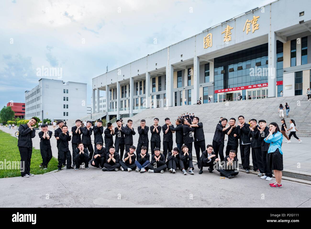 Jinzhong, Jinzhong, China. 14th June, 2018. Jinzhong, CHINA-14th June 2018: About 40 male graduates and only one female graduate poses for graduation photos at Shanxi Agricultural University in Jinzhong, north China's Shanxi Province, June 15th, 2018. Credit: SIPA Asia/ZUMA Wire/Alamy Live News Stock Photo