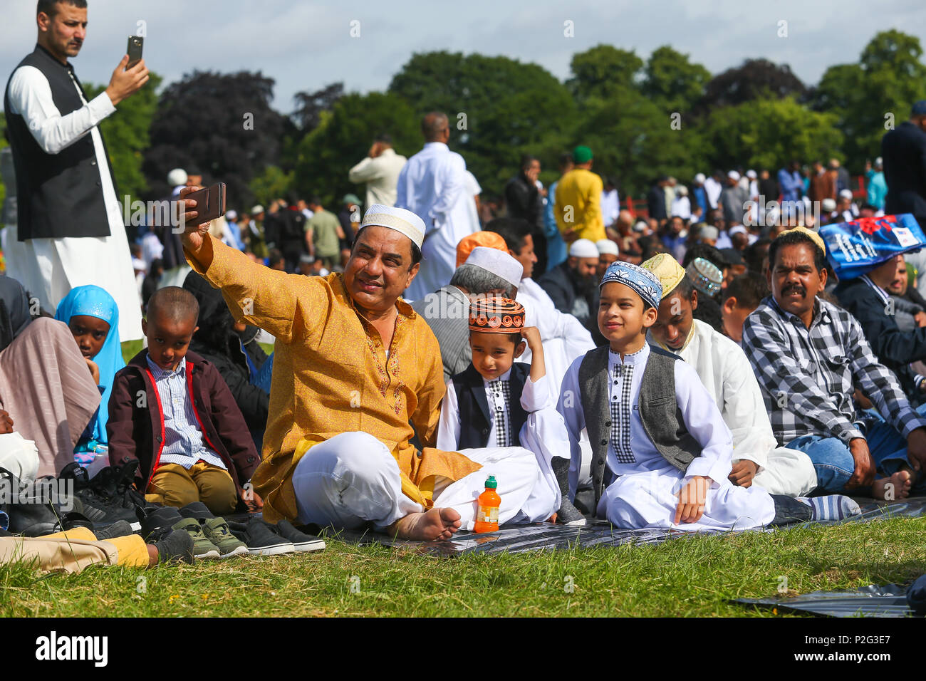 Birmingham, UK. 15th June, 2018. Over 100,000 muslims gather in Small Heath park, Birmingham, to pray on the morning of Eid, the end of the fasting month of Ramadan. Peter Lopeman/Alamy Live News Stock Photo