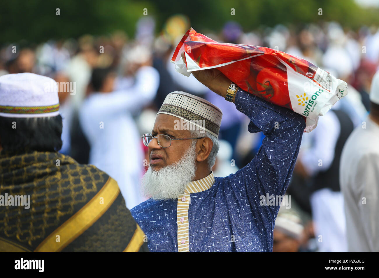 Birmingham, UK. 15th June, 2018. Over 100,000 muslims gather in Small Heath park, Birmingham, to pray on the morning of Eid, the end of the fasting month of Ramadan.Peter Lopeman/Alamy Live News Stock Photo
