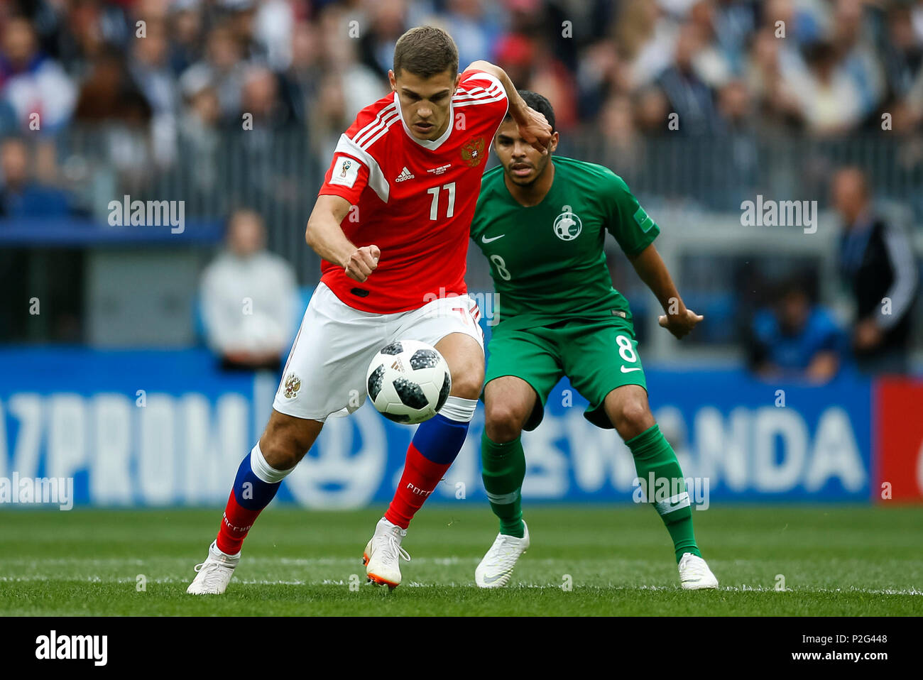 Moscow, Russia. 14th June 2018. Roman Zobnin of Russia and Yahya Al-Shehri of Saudi Arabia during the 2018 FIFA World Cup Group A match between Russia and Saudi Arabia at Luzhniki Stadium on June 14th 2018 in Moscow, Russia. Credit: PHC Images/Alamy Live News Stock Photo
