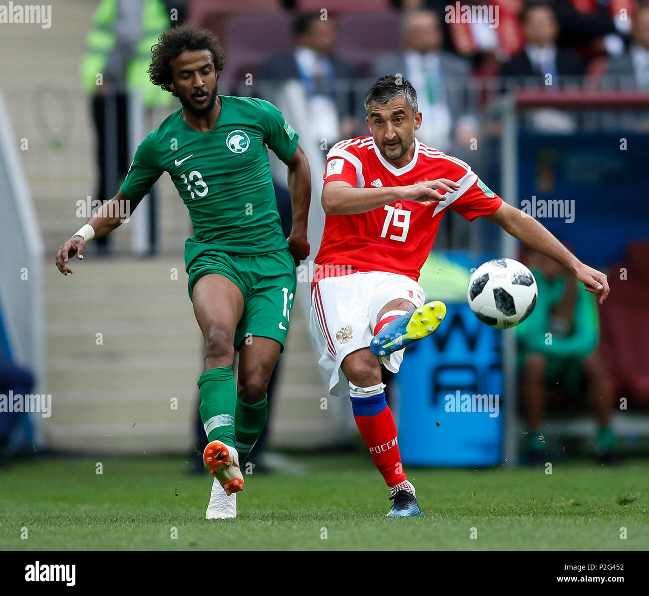 Moscow, Russia. 14th June 2018. Yasser Al-Shahrani of Saudi Arabia and Aleksandr Samedov of Russia during the 2018 FIFA World Cup Group A match between Russia and Saudi Arabia at Luzhniki Stadium on June 14th 2018 in Moscow, Russia. Credit: PHC Images/Alamy Live News Stock Photo