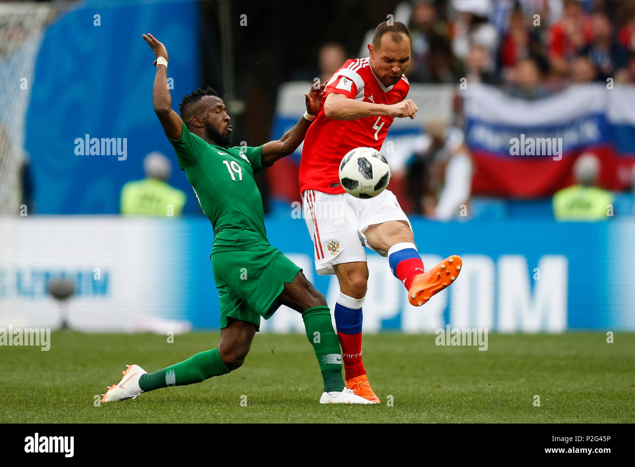 Moscow, Russia. 14th June 2018. Fahad Al-Muwallad of Saudi Arabia and Sergey Ignashevich of Russia during the 2018 FIFA World Cup Group A match between Russia and Saudi Arabia at Luzhniki Stadium on June 14th 2018 in Moscow, Russia. Credit: PHC Images/Alamy Live News Stock Photo