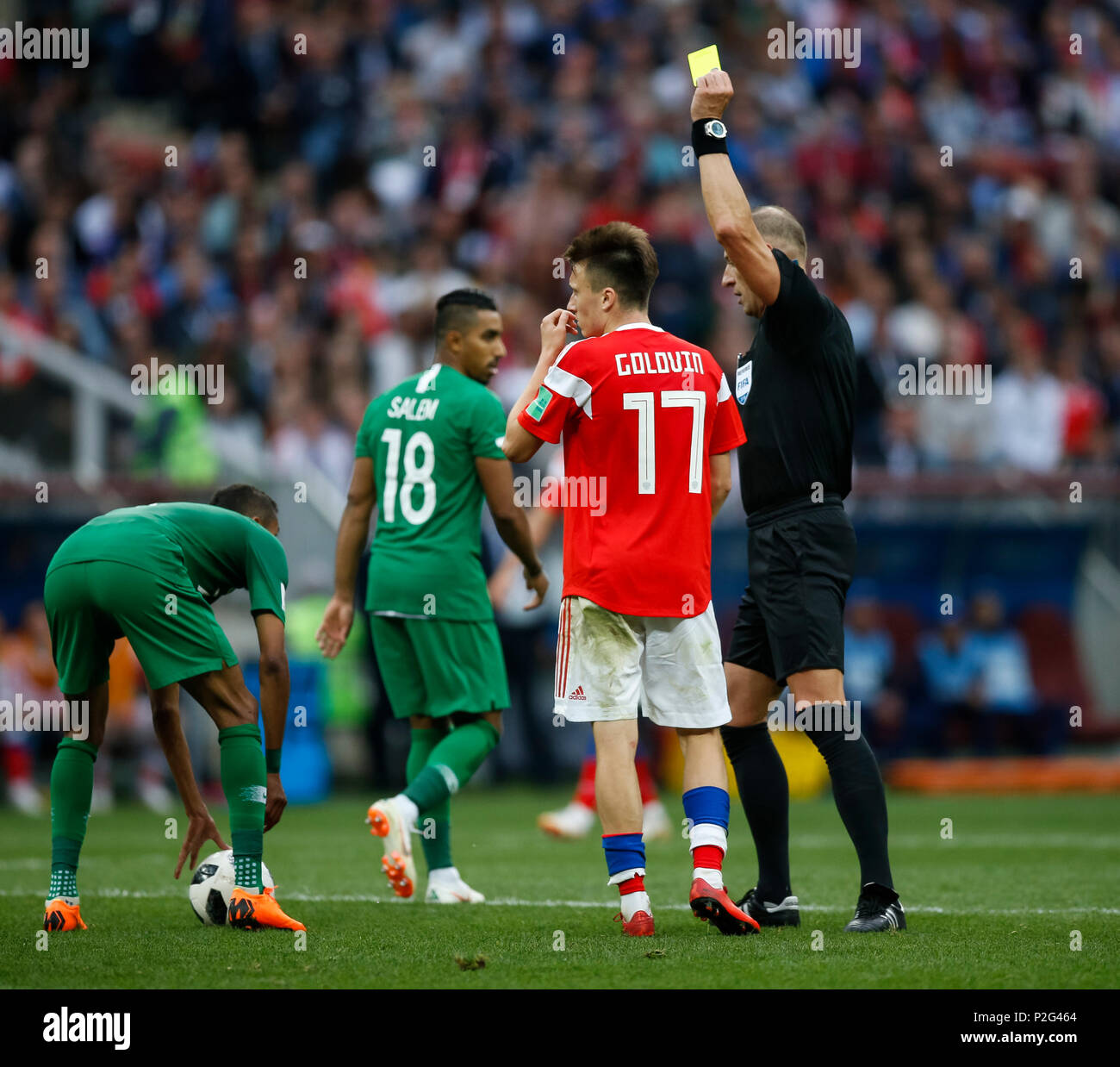 Moscow, Russia. 14th June 2018. Aleksandr Golovin of Russia is shown a yellow card by referee Nestor Pitana during the 2018 FIFA World Cup Group A match between Russia and Saudi Arabia at Luzhniki Stadium on June 14th 2018 in Moscow, Russia. Credit: PHC Images/Alamy Live News Stock Photo