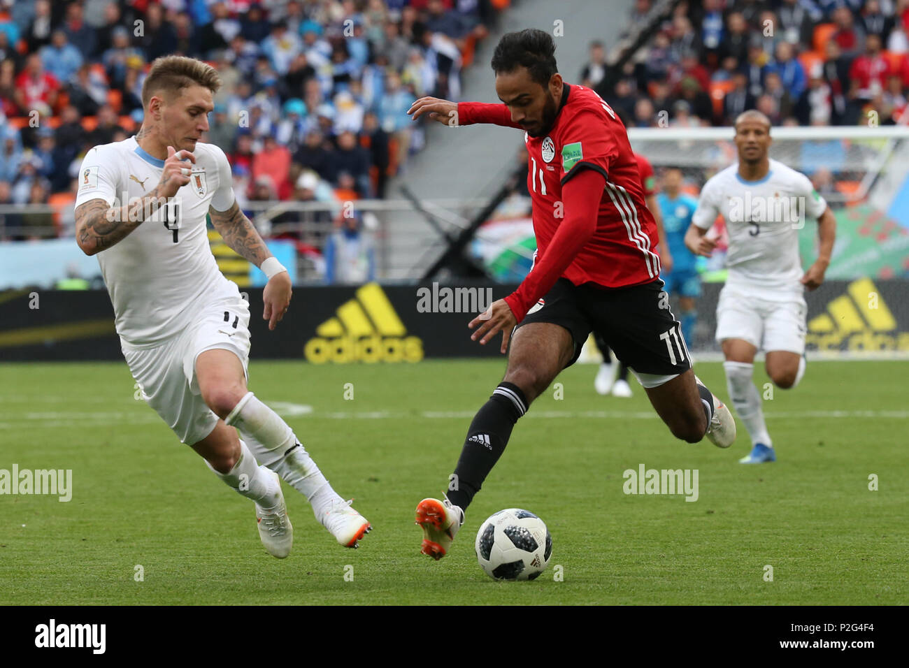 Yekaterinburg, Russia. 15th June, 2018. Uruguay's Guillermo Varela (L) battles for the ball with Egypt's Kahraba during the FIFA World Cup 2018 Group A soccer match between Egypt and Uruguay at the Ekaterinburg Arena in Yekaterinburg, Russia, 15 June 2018. Credit: Ahmed Ramadan/dpa/Alamy Live News Stock Photo