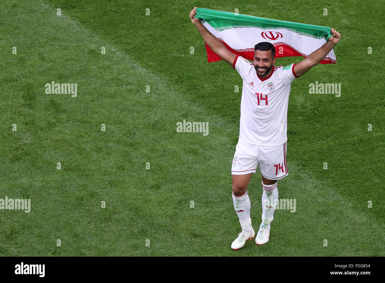 Saint Petersburg, Russia. 15th June, 2018. Iran's Saman Ghoddos holds his country's national flag as he celebrates his team win after the final whistle of the FIFA World Cup 2018 Group B soccer match between Iran and Morocco at the Saint Petersburg Stadium, in Saint Petersburg, Russia, 15 June 2018. Credit: Saeid Zareian/dpa/Alamy Live News Stock Photo