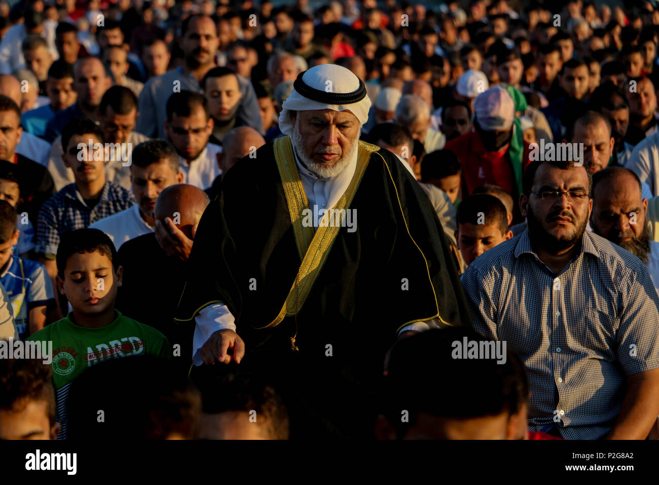 June 15, 2018 - Palestinian Muslims in Gaza celebrate Eid al-Fitr in the 'Return'' refugee camp along the eastern Gaza border, marking the end of the fasting month of Ramadan. Hamas political bureau chief, Ismail Haniya, and Hamas senior leader, Dr Khalil Al-Hayia, attended the al-Fitr celebrations and performed the Eid al-Fitr prayers alongside the other worshippers in the camp's open square. The 'Return'' refugee camp is located in the northeast of Gaza, close to the Nahal Oz border crossing. Eid al-Fitr is an important religious holiday for Muslims worldwide and it marks the end of Stock Photo