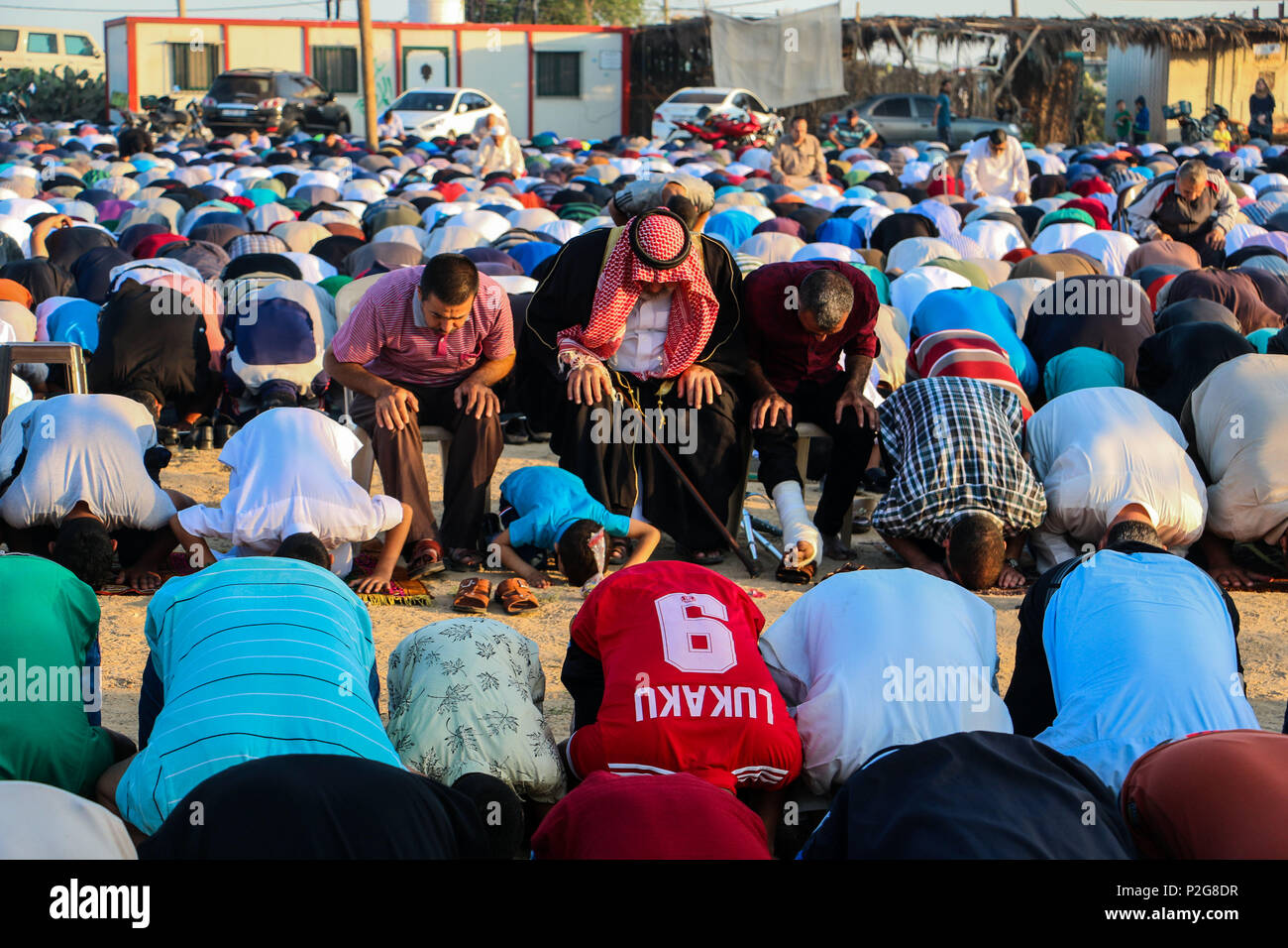 June 15, 2018 - Palestinian Muslims in Gaza celebrate Eid al-Fitr in the 'Return'' refugee camp along the eastern Gaza border, marking the end of the fasting month of Ramadan. Hamas political bureau chief, Ismail Haniya, and Hamas senior leader, Dr Khalil Al-Hayia, attended the al-Fitr celebrations and performed the Eid al-Fitr prayers alongside the other worshippers in the camp's open square. The 'Return'' refugee camp is located in the northeast of Gaza, close to the Nahal Oz border crossing. Eid al-Fitr is an important religious holiday for Muslims worldwide and it marks the end of Stock Photo