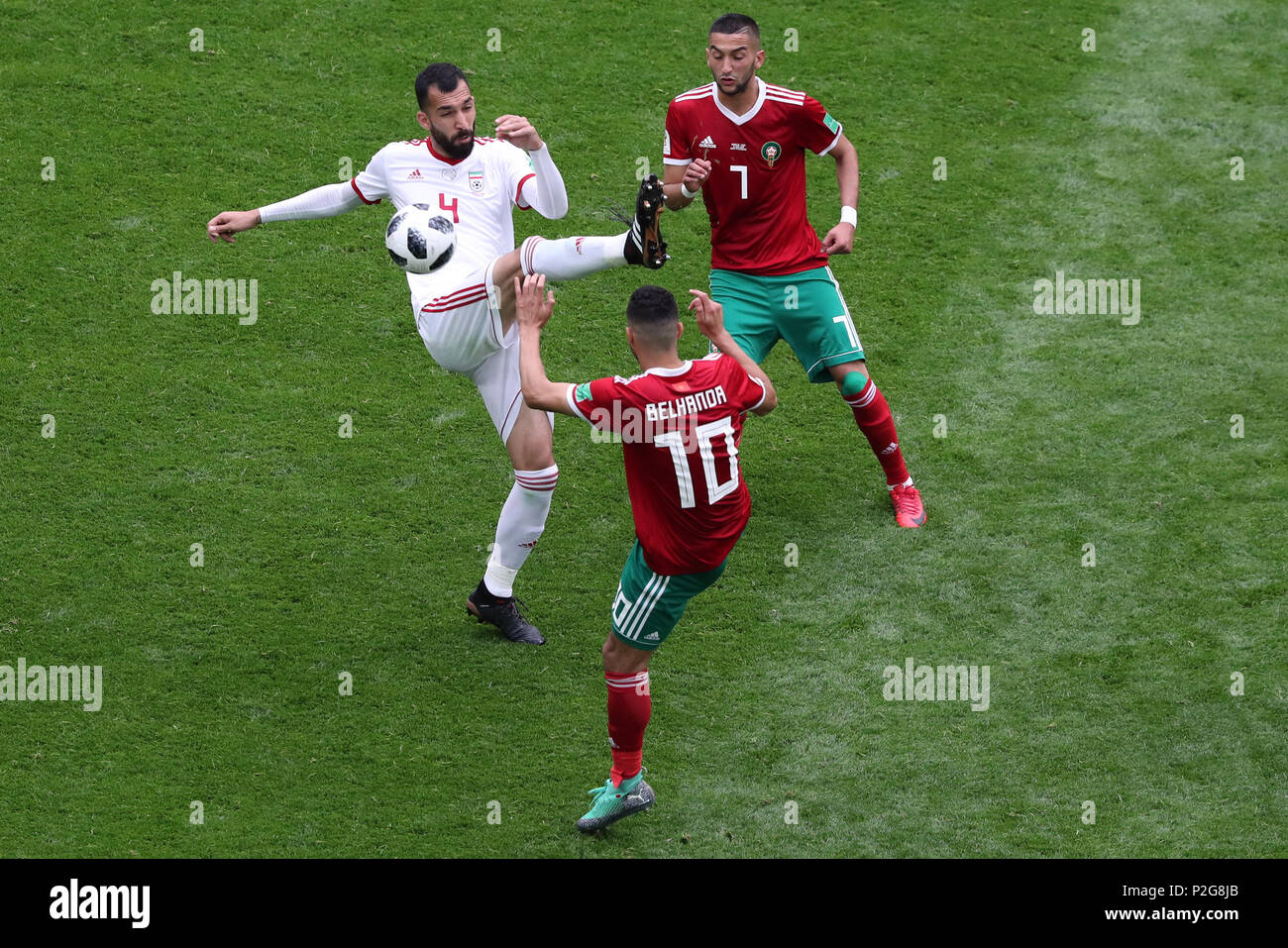 Saint Petersburg, Russia. 15th June, 2018. Iran's Rouzbeh Cheshmi (L) in action against Morocco's Hakim Ziyech (R) and Younes Belhanda during the FIFA World Cup 2018 Group B soccer match between Iran and Morocco at the Saint Petersburg Stadium, in Saint Petersburg, Russia, 15 June 2018. Credit: Saeid Zareian/dpa/Alamy Live News Stock Photo