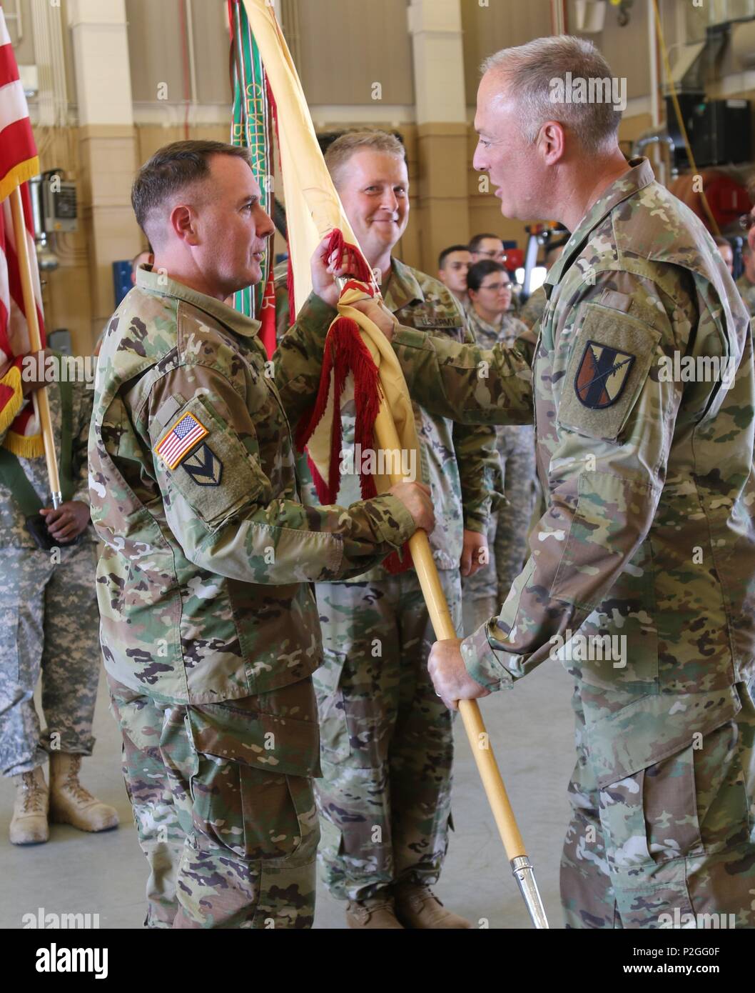 Lt. Col. Peter F. Gleason, a Tracy, California resident and 63rd Brigade Support Battalion incoming commander, is passed the unit guidon from Col. Joseph Riciardi, 303rd Maneuver Enhancement Brigade commander, and assumed command of the 63rd BSB from Lt. Col. Debra A. Cisney, who has led the unit for the past two years, at the George W. Dunaway Army Reserve Center in Sloan, Nev. September 10. Stock Photo