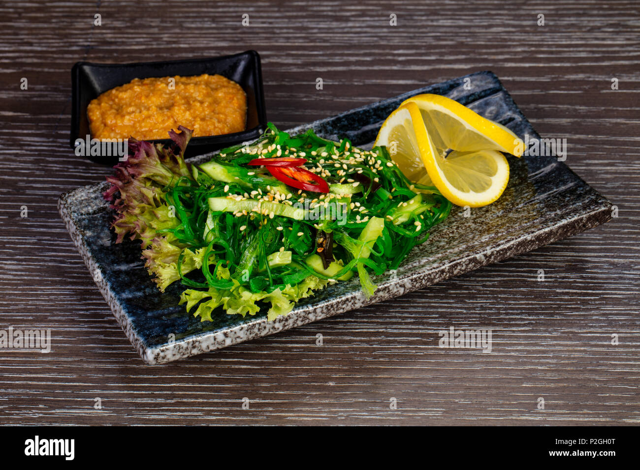 Bright green kaiso salad with lemon Stock Photo Alamy