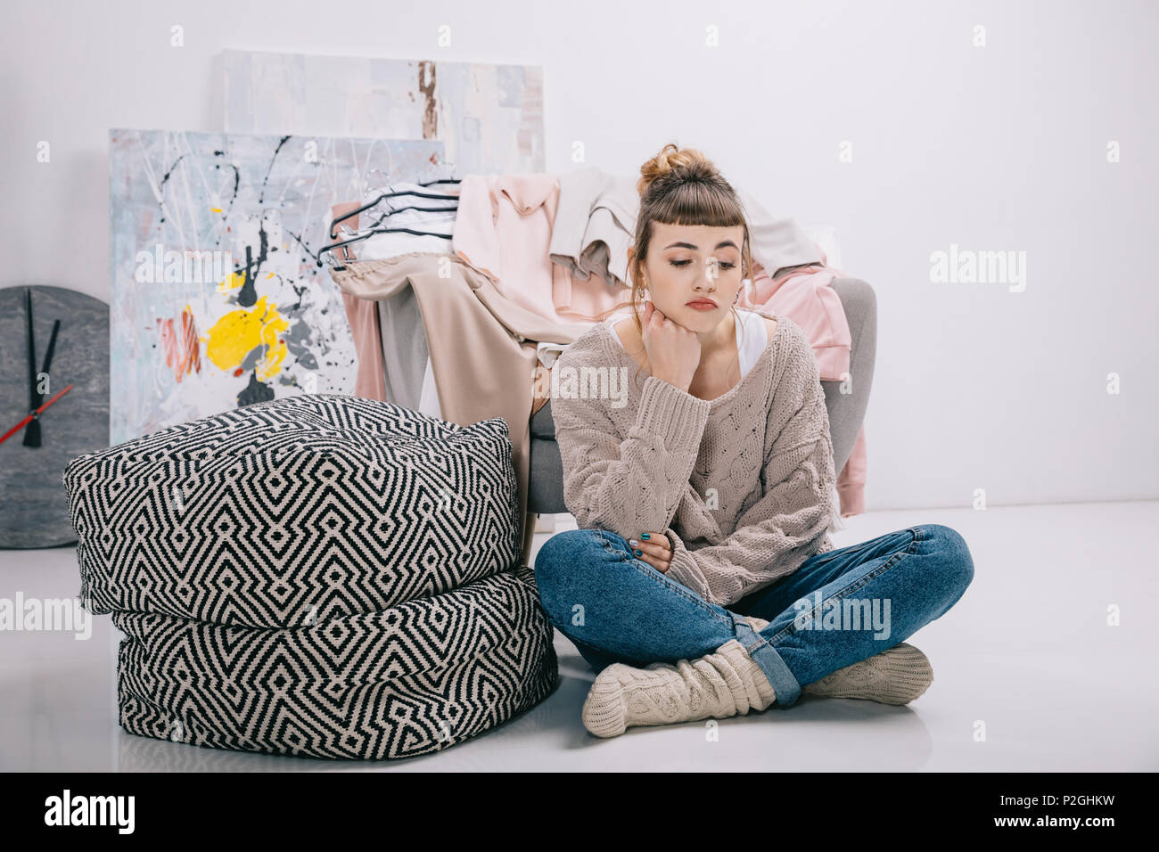 upset girl sitting on floor and looking down Stock Photo - Alamy