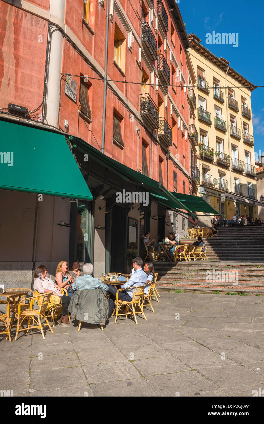 Madrid street cafe, people relax at terrace tables outside bars in the Calle Nuncio in the La Latina quarter of Madrid, Spain. Stock Photo