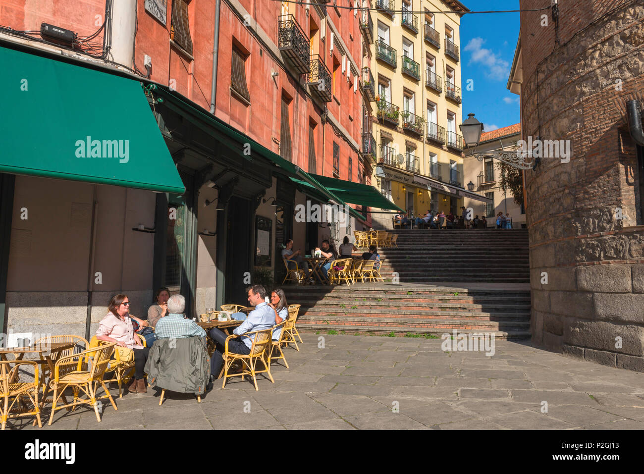 Madrid street cafe, view in summer of people relaxing at terrace tables outside bars in the Calle Nuncio in the La Latina quarter of Madrid, Spain. Stock Photo