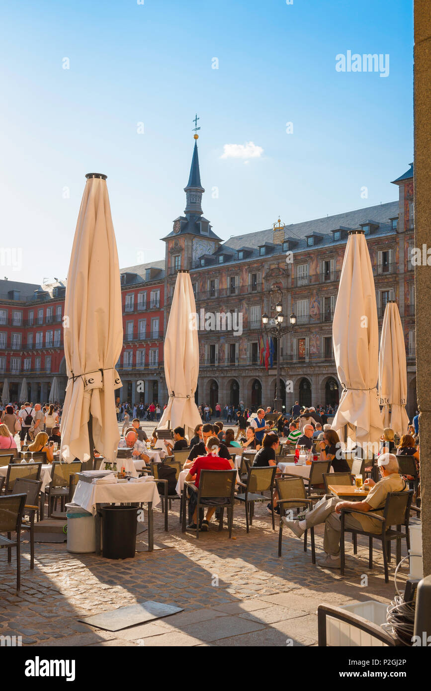 Madrid cafe Plaza Mayor, view of people relaxing at terrace tables outside cafes in the main square of Madrid - the 17th century Plaza Mayor, Spain. Stock Photo