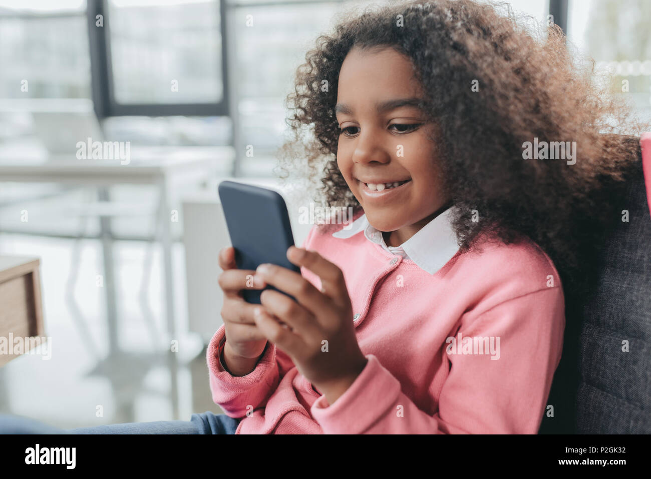 Little Happy African American Girl With Curly Hair Using