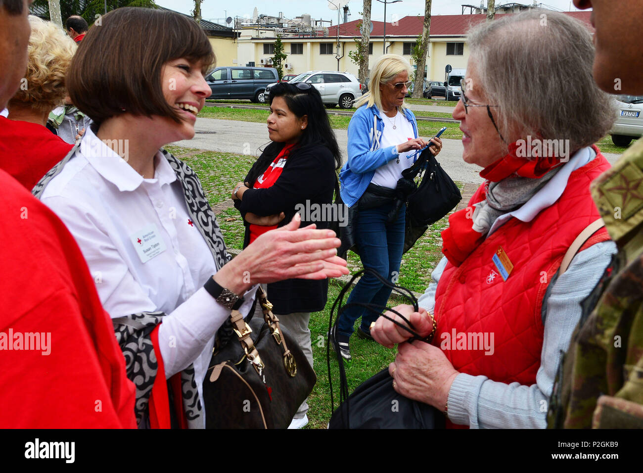 Ms. Susan Tipton, Regional Program Director Italy/Spain Region, of the American Red Cross (left), greets Ms. Maria Giulia Medolago Albani, Sovereign Military Order of Malta (right), during the visit at caserma Ederle, 22 Sept. 2016, Vicenza, Italy. The Sovereign Military Order of Malta (SMOM) or Order of Malta, is a Roman Catholic religious order traditionally of military, chivalrous and noble nature for defense of Catholic faith and assistance to the poor. (U.S. Army photo by Visual Information Specialist Paolo Bovo/Released) Stock Photo